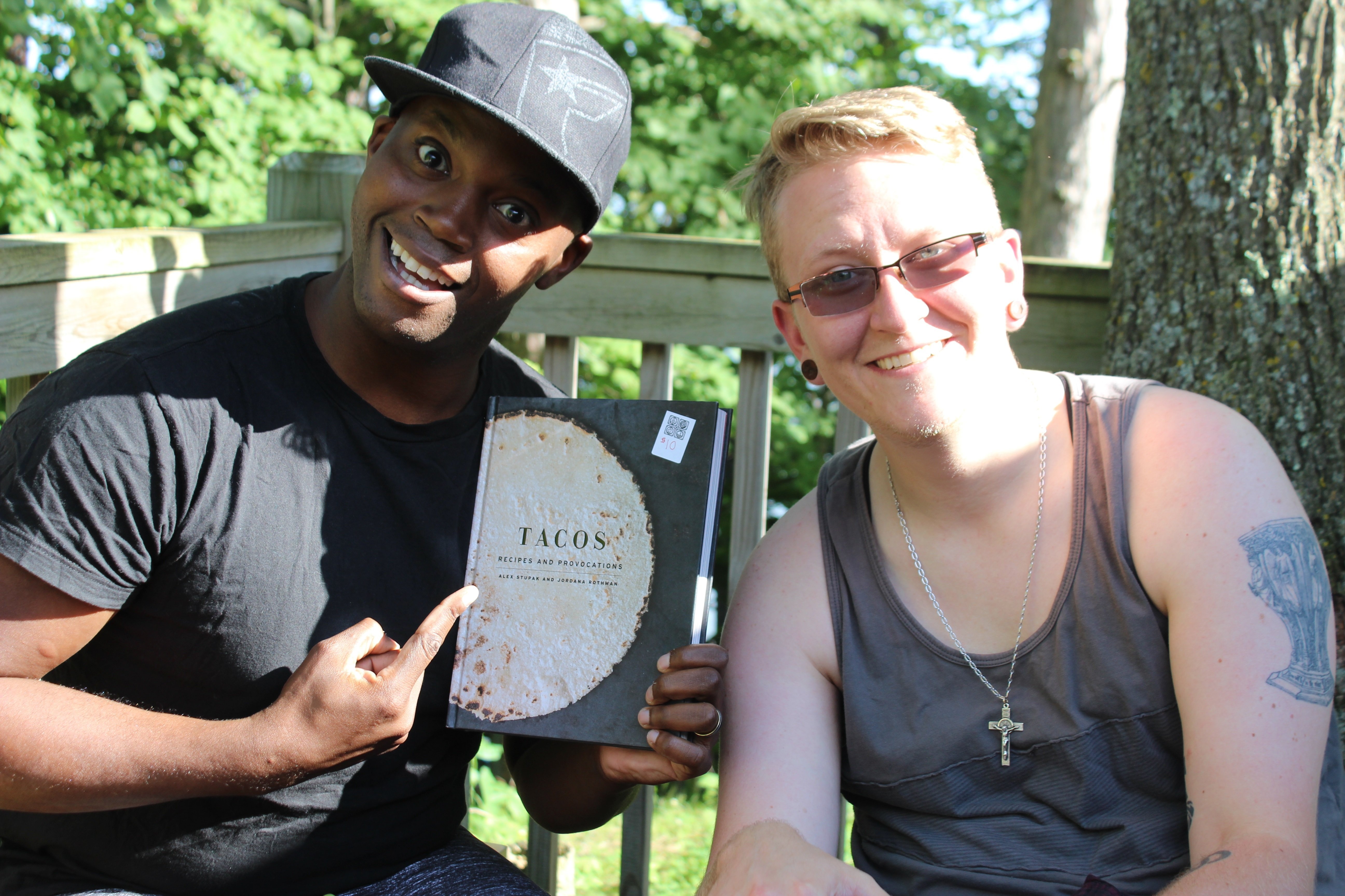 Dwaine holding a recipe book for tacos